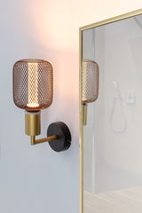 Wandlampe mit goldfarbenem Metallarm und schwarzem Gitterschirm, warmes Licht für modernes Interieur