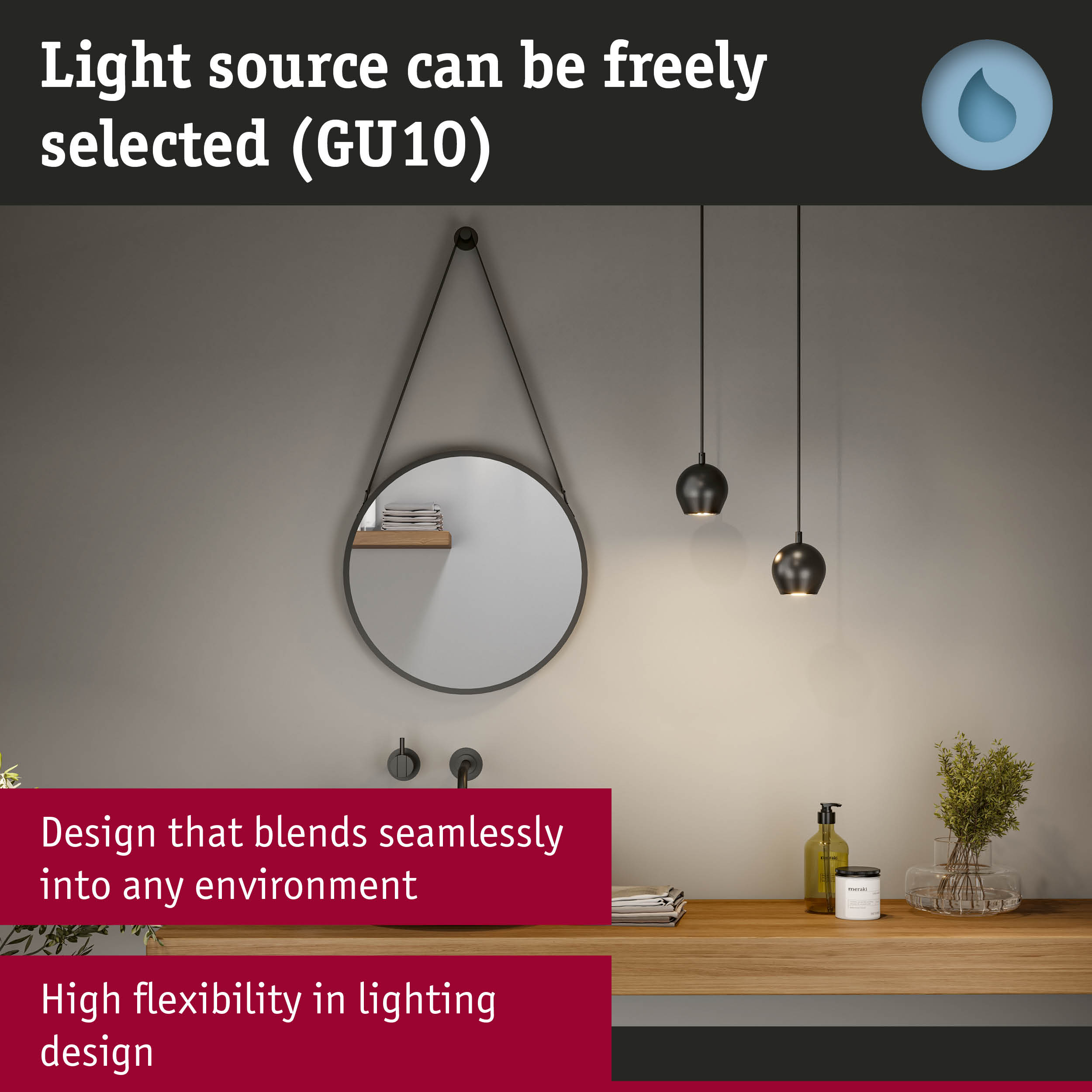 Black metal pendant lights above wooden shelf with round mirror and bathroom accessories