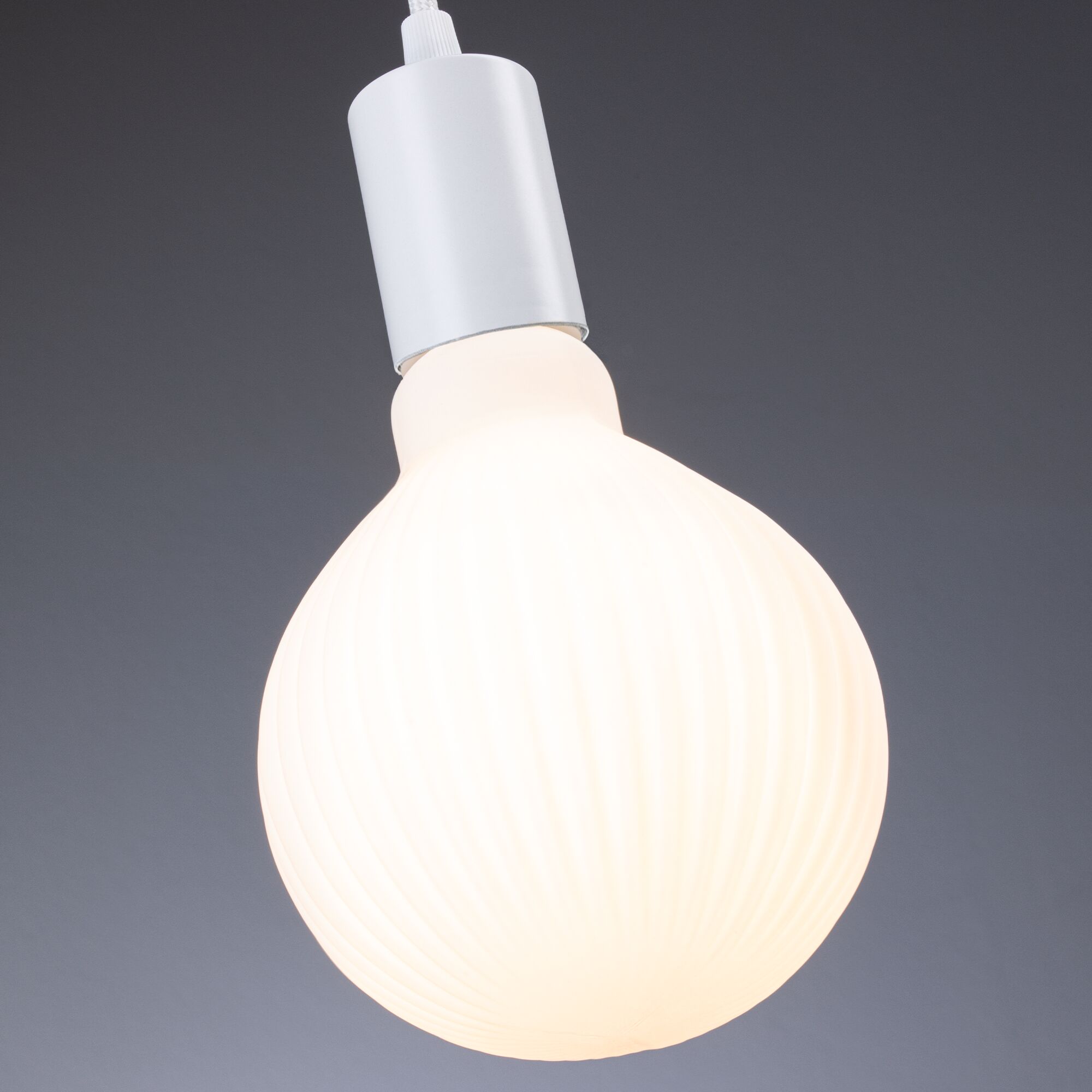 White LED lamp with ribbed surface and white plastic base for modern lighting solutions