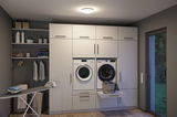Modern white built-in laundry room with washing machine, dryer, and integrated laundry basket drawer