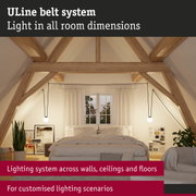 Modern bedroom with exposed wooden beams and customizable lighting system for tailored ambiance