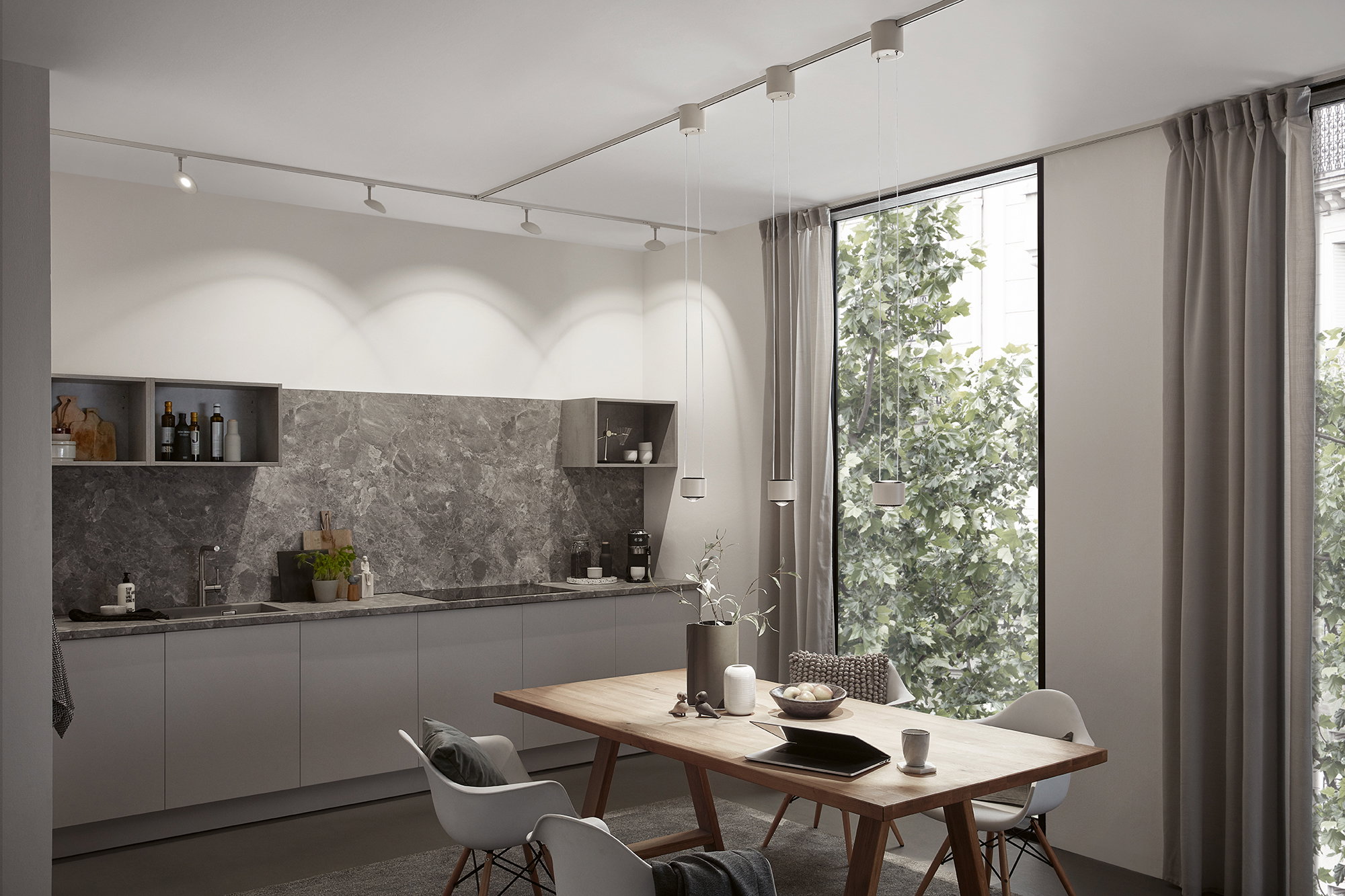 Modern kitchen with grey cabinets, marble countertop and minimalist pendant lighting for stylish home illumination