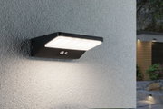 Black LED outdoor wall light with motion sensor on grey wall for garden lighting