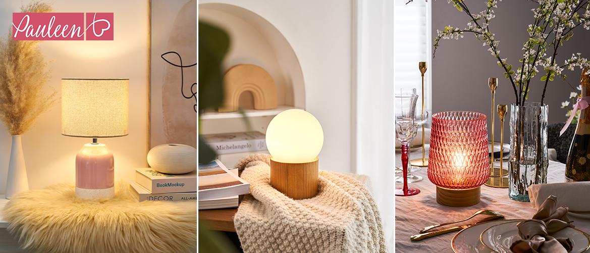 Drei dekorative Tischlampen in Rosa, Holz und Rot mit warmem Licht für gemütliche Wohnraumbeleuchtung.
