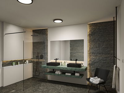 Modern bathroom with green marble vanity, black basins, and indirect LED lighting for ambiance.