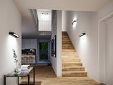 Modern hallway with wooden stairs and black LED wall lights for ambient home lighting