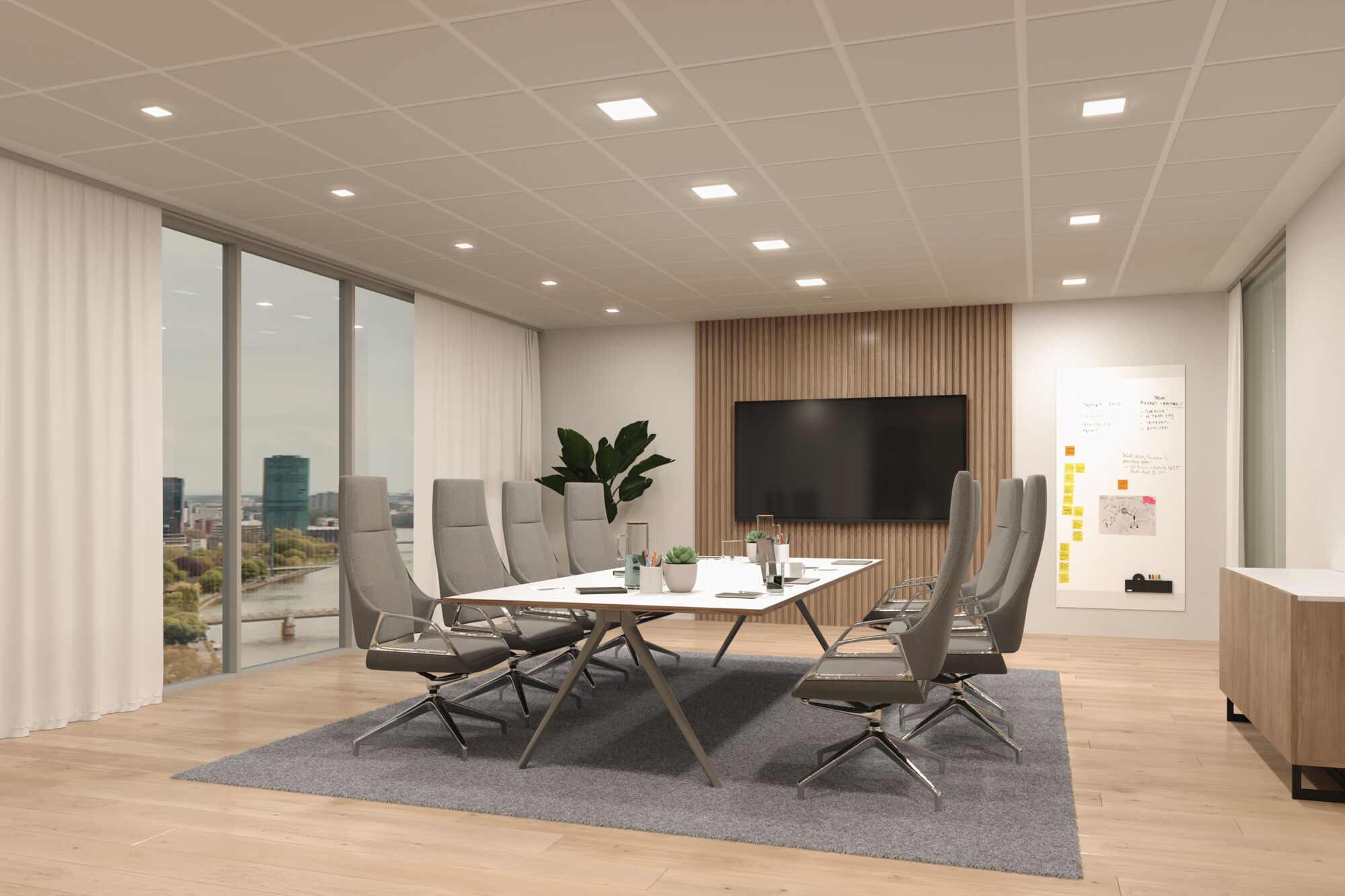 Modernes Konferenzzimmer mit grauen Bürostühlen, weißem Tisch und LED-Deckenleuchten in Bürobeleuchtung