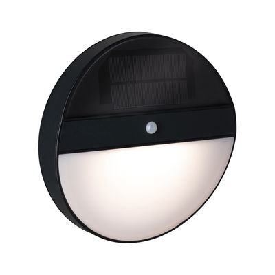 Round black solar wall light with motion sensor and white diffuser for outdoor lighting