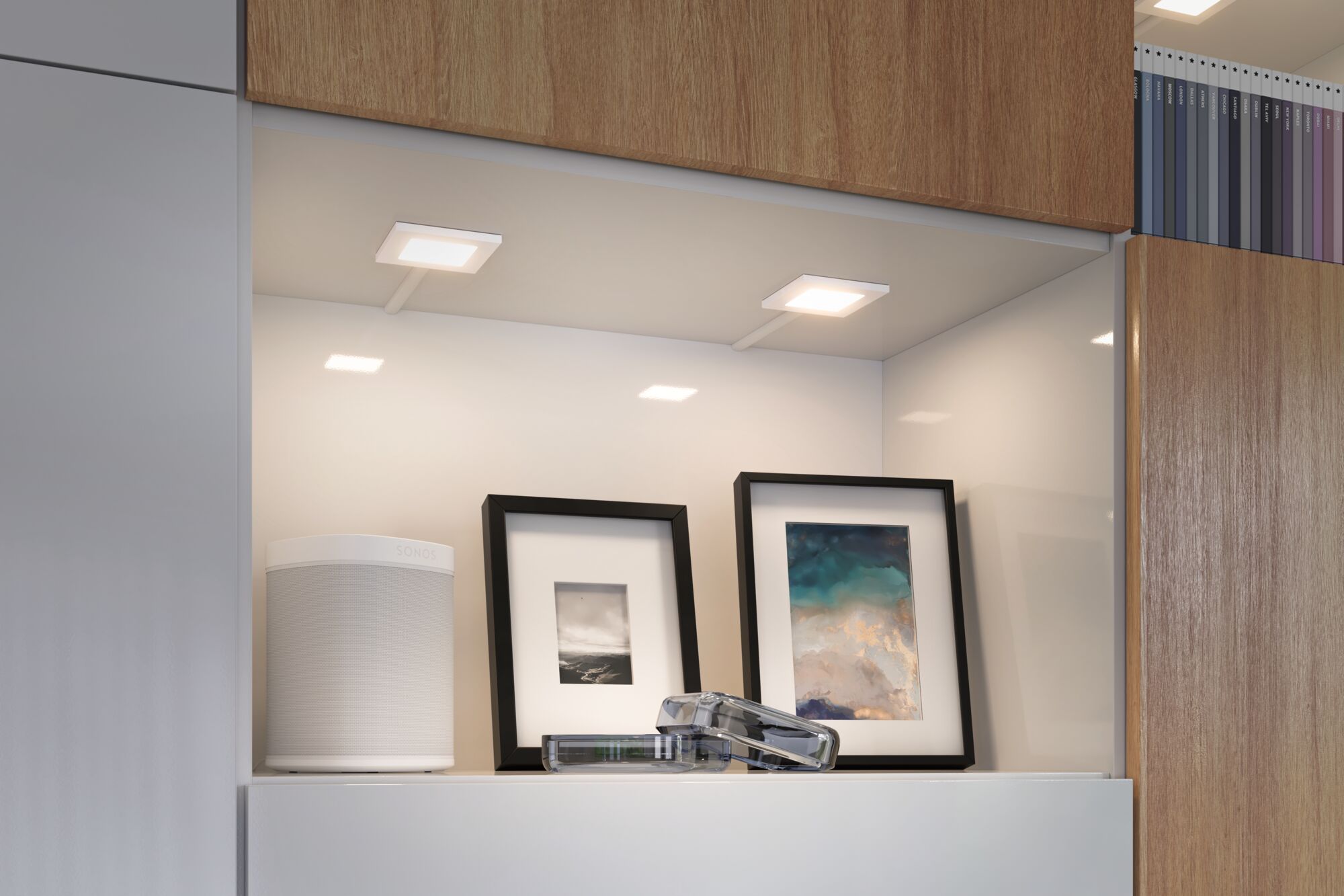 Lumières LED blanches modernes sous meuble dans étagère de cuisine avec haut-parleur et cadres photo