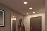 Flat white LED recessed lights in ceiling of modern hallway with gray door and coat rack