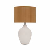 Table lamp with white ceramic base and brown fabric shade for cozy home lighting