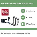 Starter set with three black LED outdoor spotlights, cables, and transformer for garden lighting.