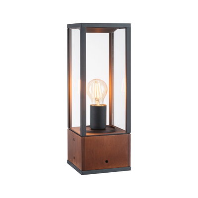 Modern table lamp with wooden base and black metal frame, clear glass panels, visible filament bulb