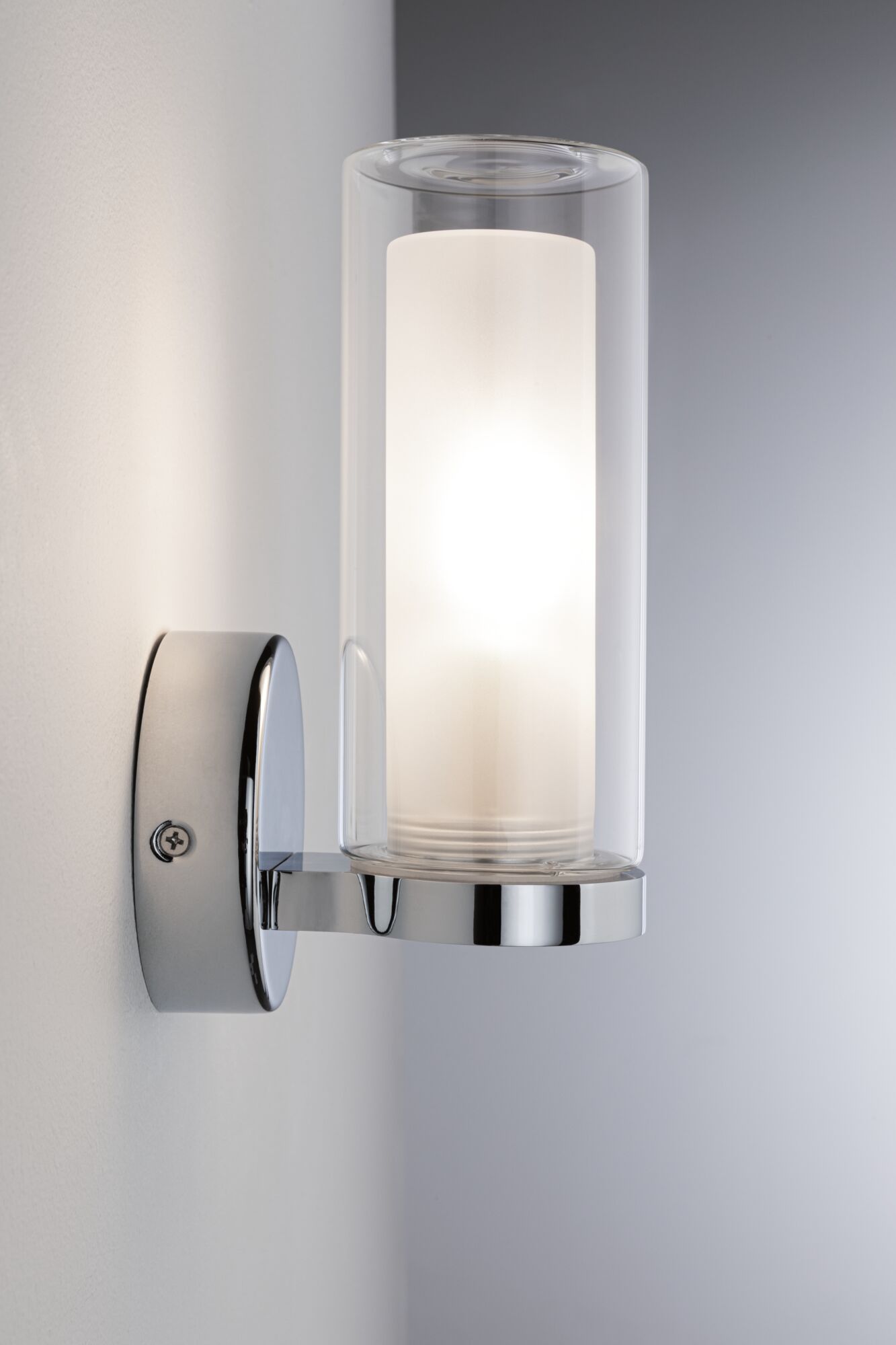 Modern wall lamp with clear glass and chrome metal, warm white light for living spaces.