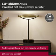 LED-tafellamp Melira met modern gouden ringontwerp en zwarte voet, dimbaar in 3 stappen