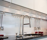 Modern kitchen countertop with black granite surface and chrome faucet with flexible hose design