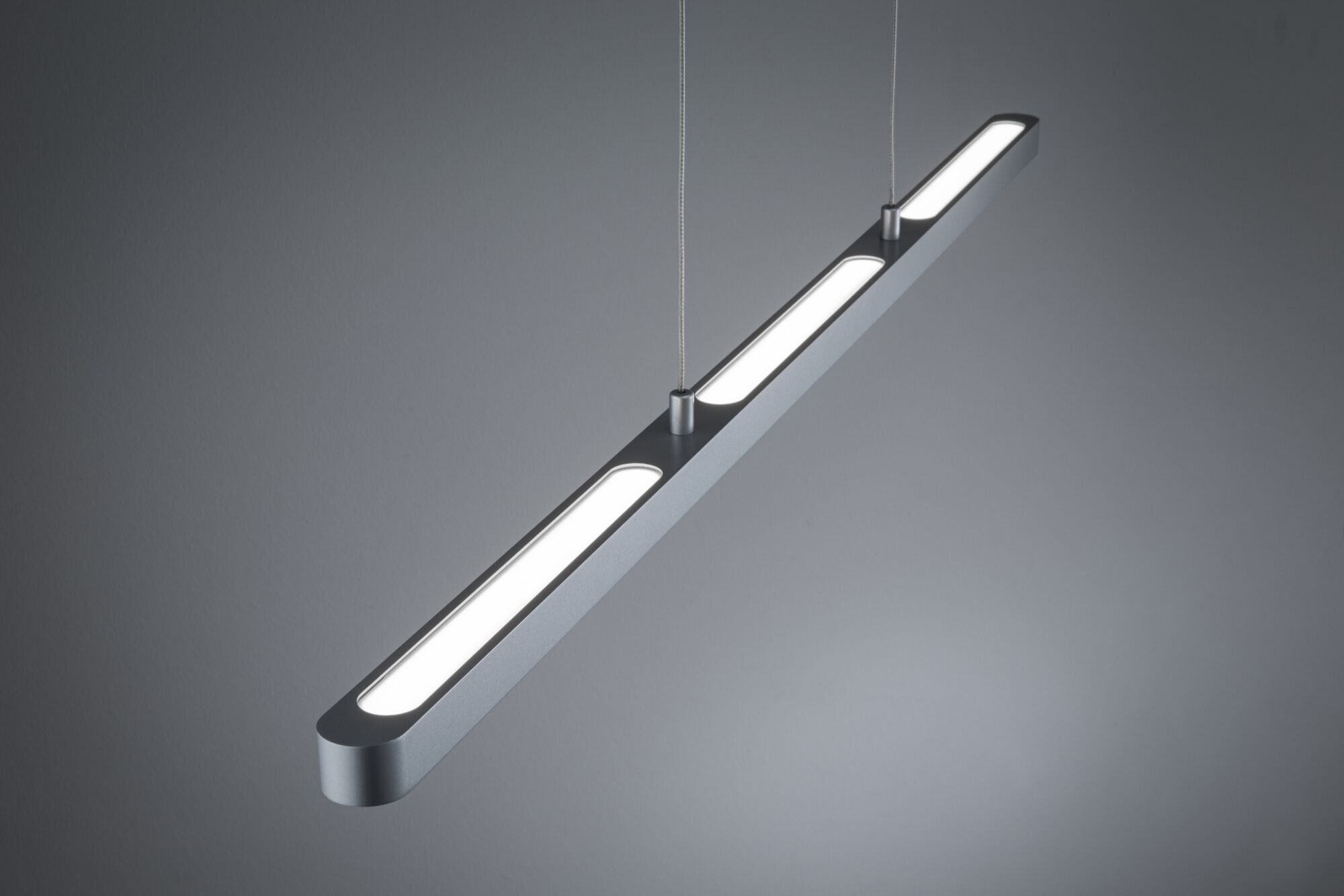 Modern silver aluminum LED pendant light with three elongated light panels for living spaces.