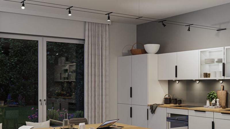 Cuisine blanche moderne avec plan de travail en bois et spots LED noirs Paulmann sur rail d'éclairage.