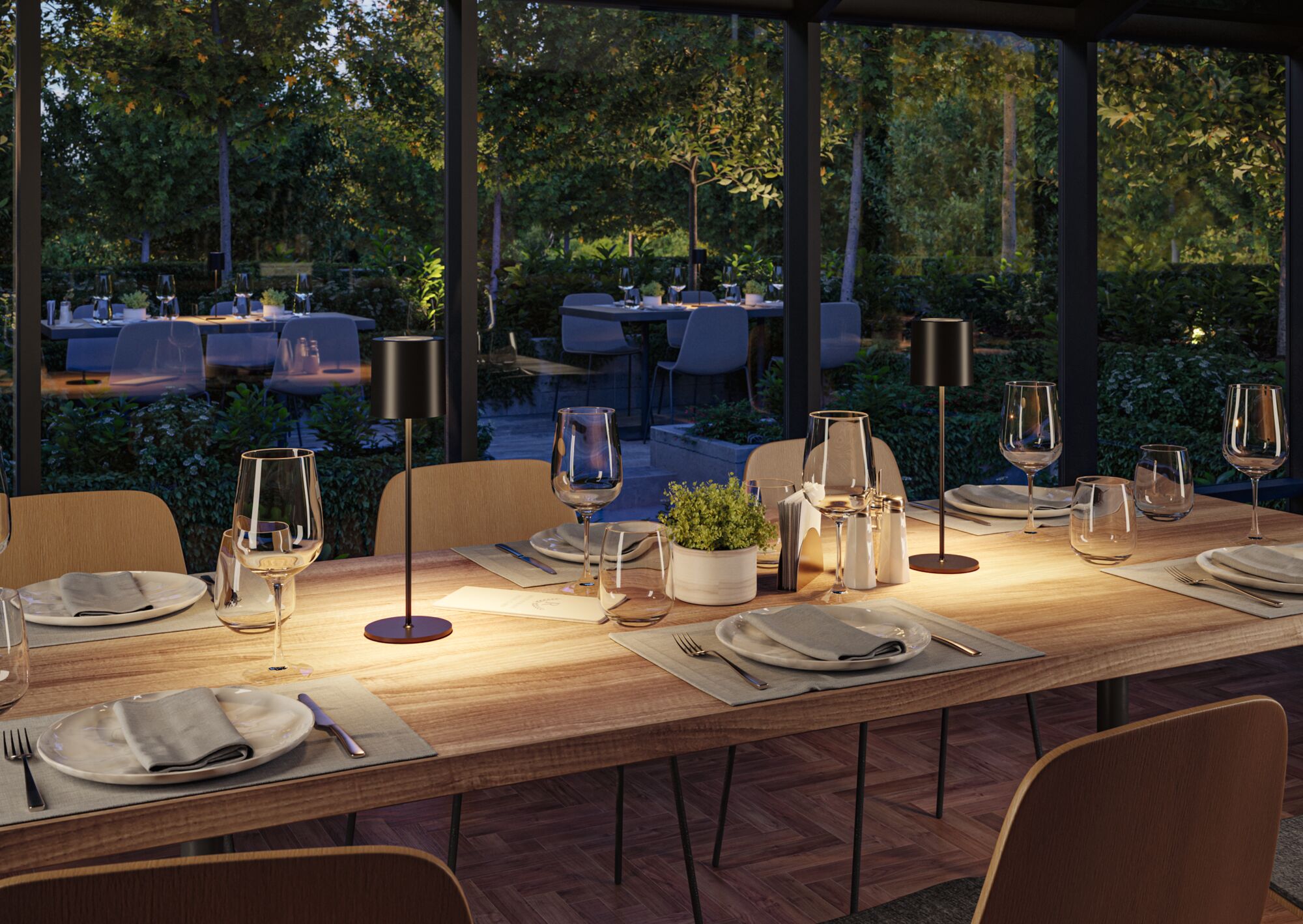 Modern wooden dining table with black LED table lamps and set places in cozy dining room lighting.