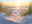 Sunrise at beach with sand dunes and icon representing smart home lighting control and timer