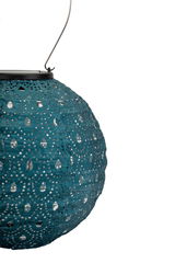 Round blue paper lantern with perforated pattern and metal handle for decorative indoor lighting