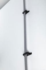 Grey fabric strap with black brackets on white wall for cable management and organization