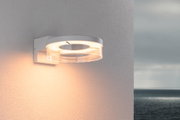 Modern white LED wall light with transparent ring and warm white light for outdoor use.