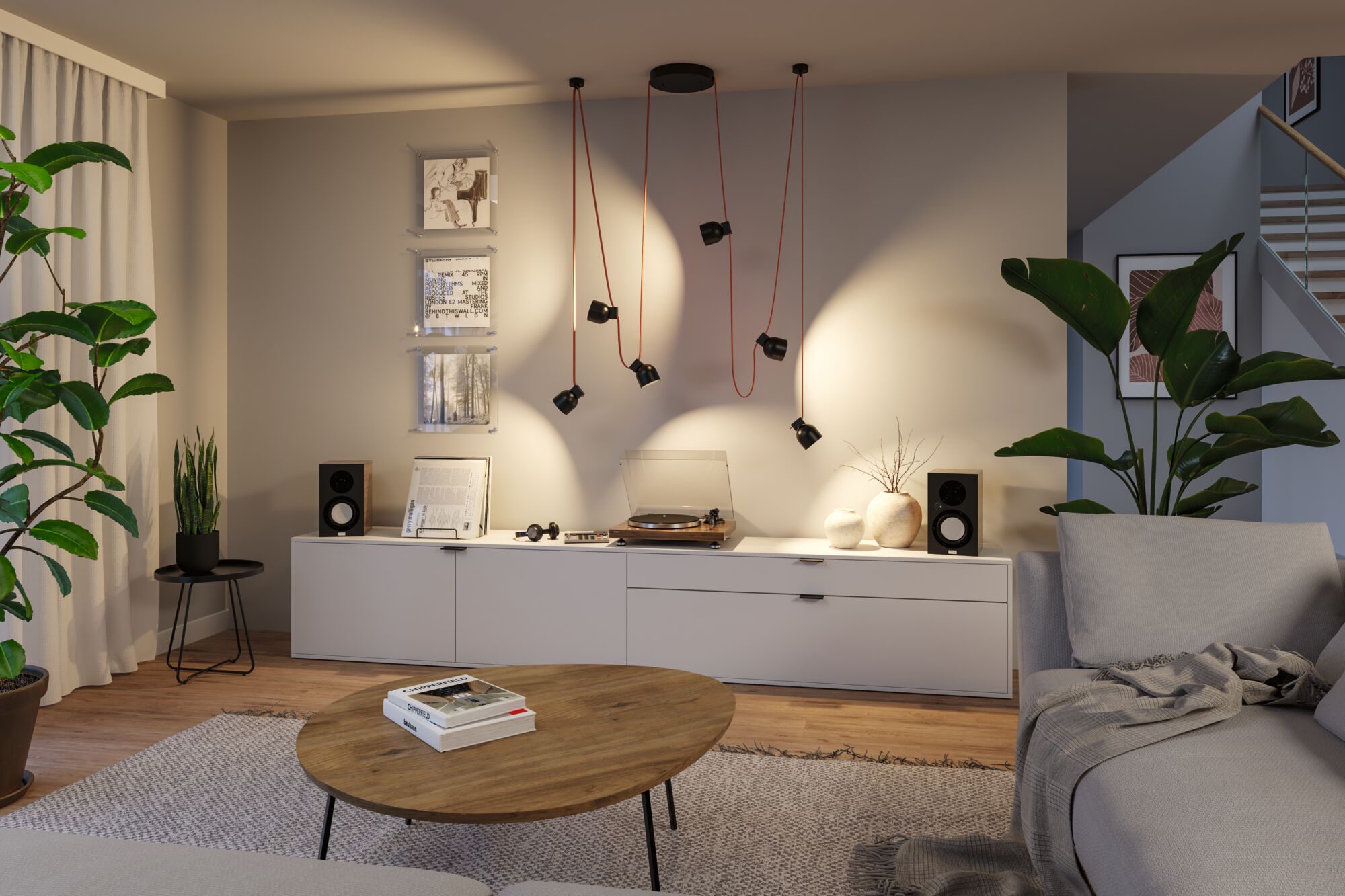Modern living room lighting with black metal pendant lamp and red cables above sideboard with turntable.