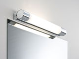 Modern bathroom light with chrome metal housing and white glass mounted above mirror, LED lighting