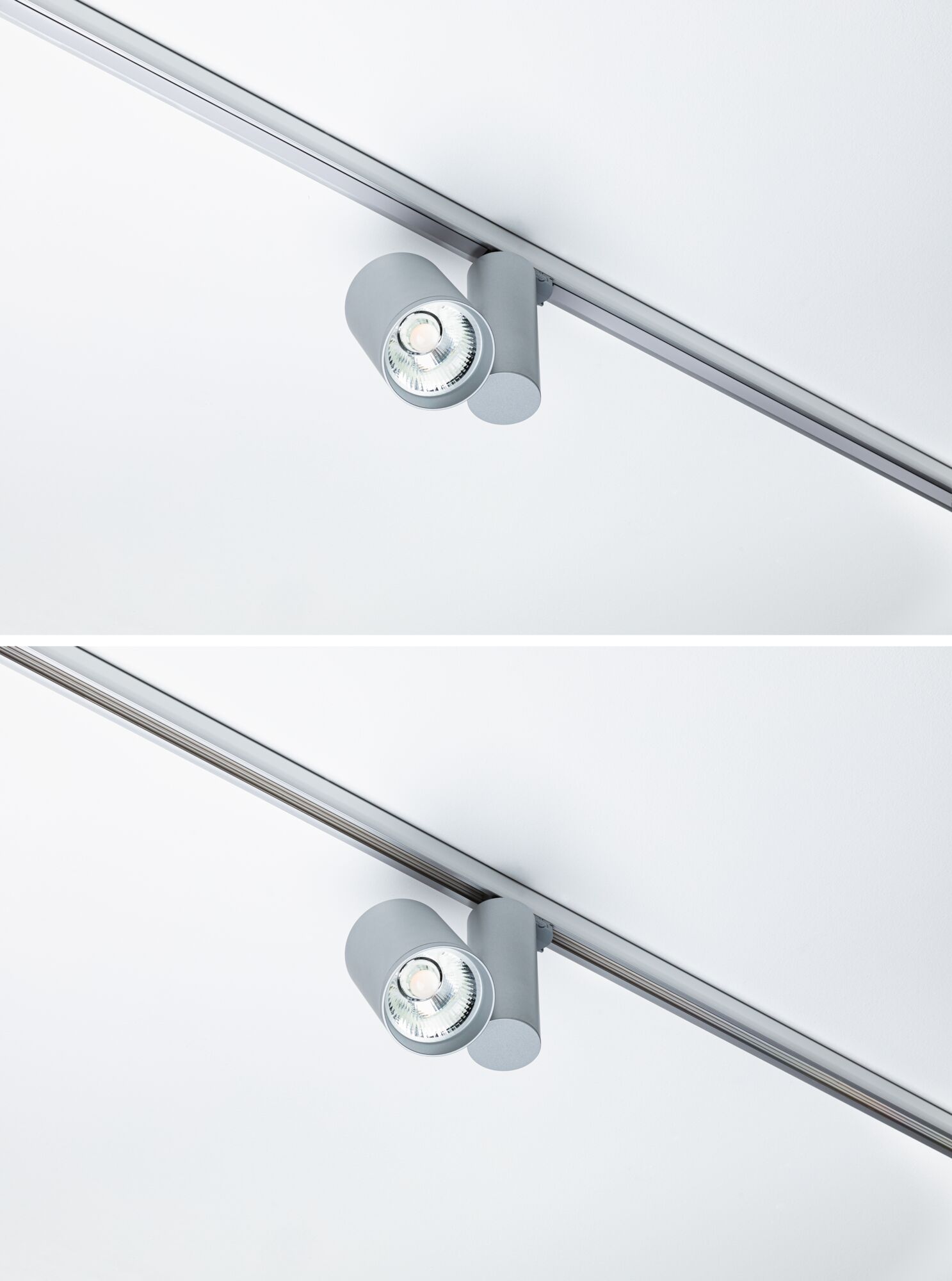 Moderner grauer LED-Strahler aus Metall an Schienensystem für flexible Deckenbeleuchtung