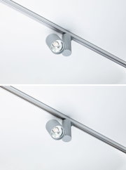 Moderner grauer LED-Strahler aus Metall an Schienensystem für flexible Deckenbeleuchtung