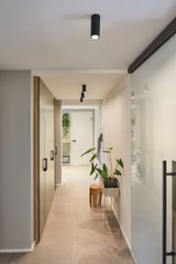 Modern hallway with black metal ceiling spotlights and minimalist decor for stylish home lighting