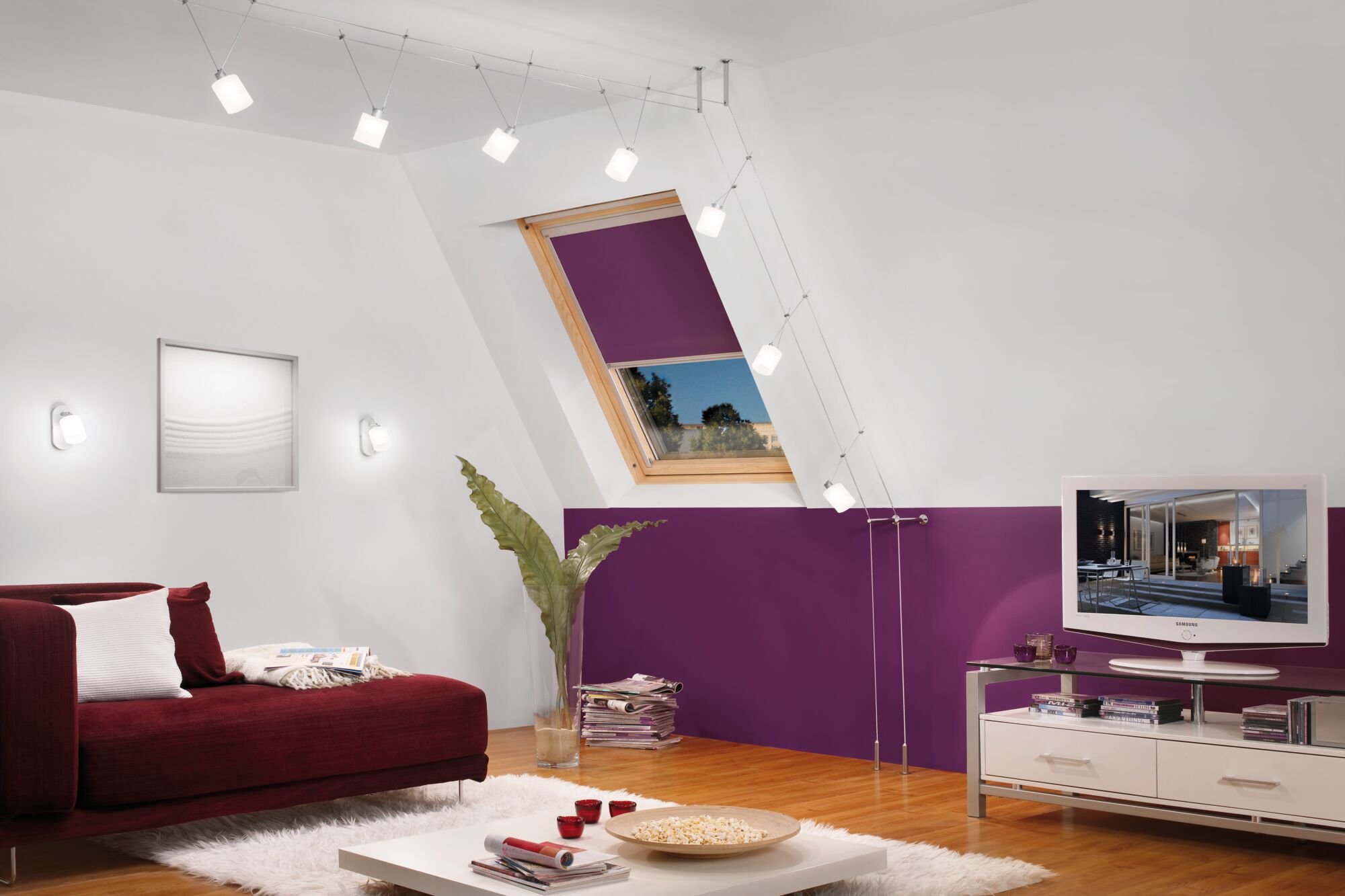 Modern living room with red sofa, purple wall paint and white LED cable lighting on ceiling