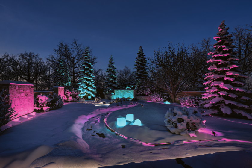 Snow-covered garden with blue and pink LED outdoor lighting for decorative garden illumination.