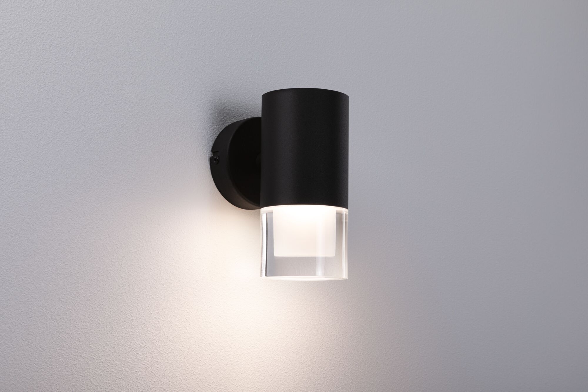 Black metal wall lamp with clear glass and warm white light for modern indoor lighting