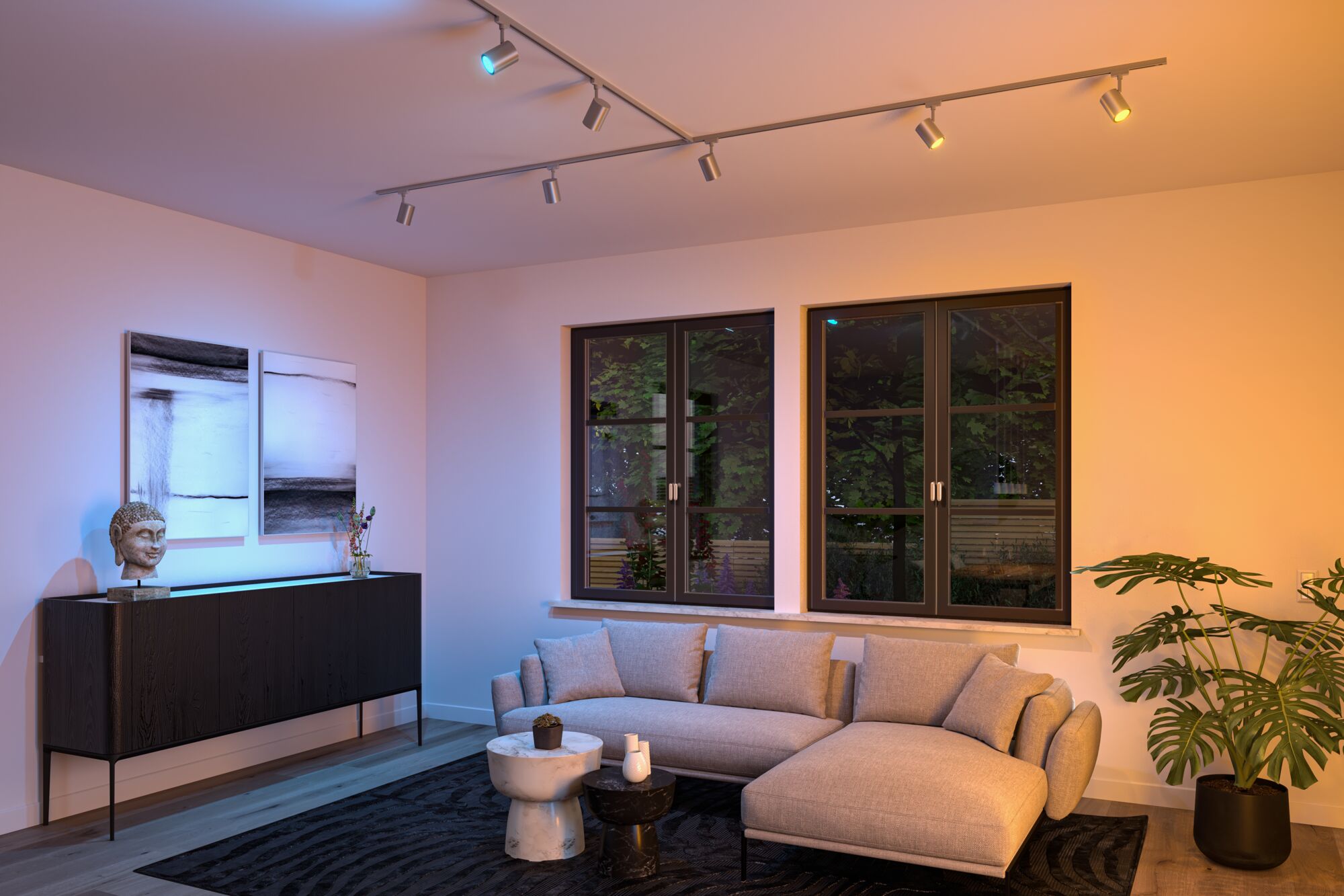 Salon moderne avec canapé en tissu gris, meubles noirs et spots LED colorés au plafond pour éclairage d'accent