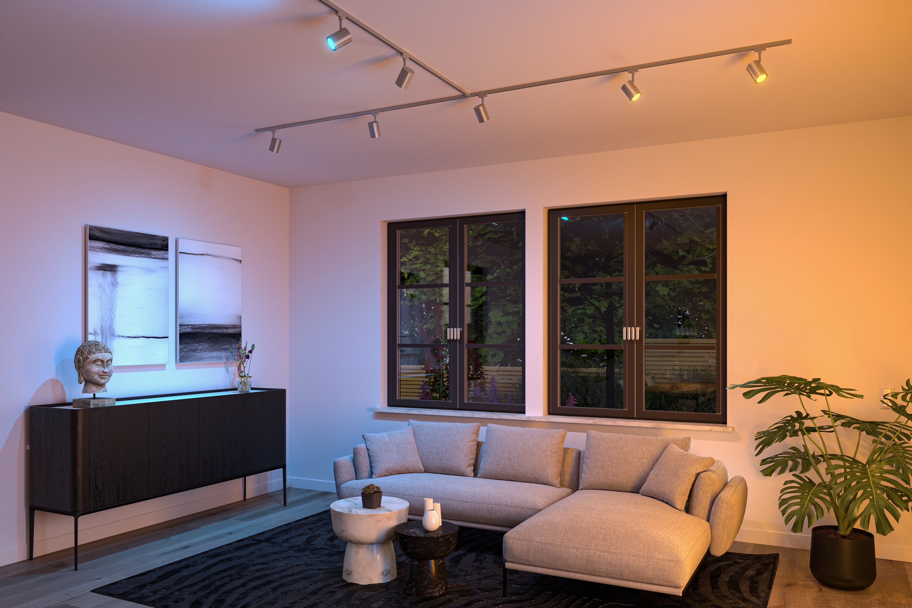 Modern silver LED track lights on ceiling illuminate living room with grey sofa and plants