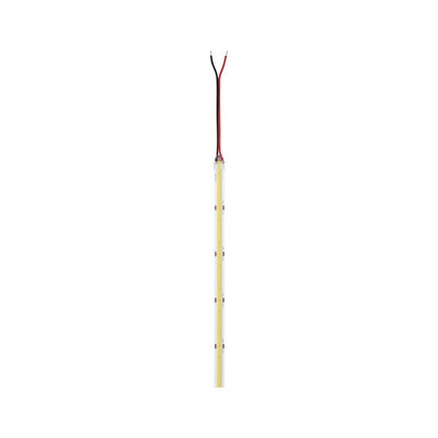 Slim LED light strip with transparent casing and red and black connection wires for lighting solutions.