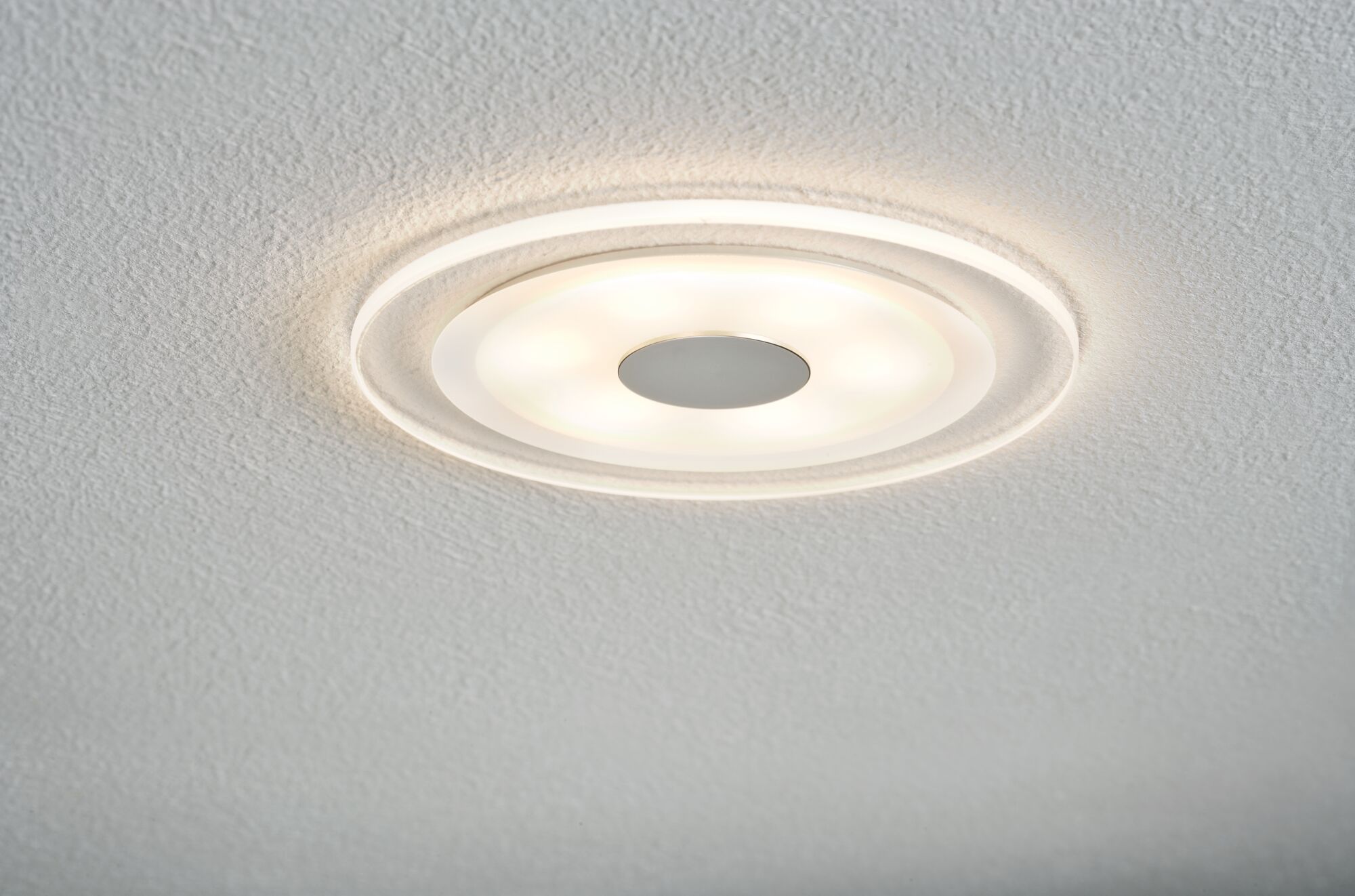 Round LED ceiling light with white plastic and warm white light for modern living spaces