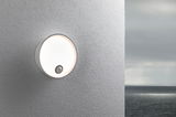 Round white outdoor wall light with motion sensor on grey wall, ideal for outdoor lighting.