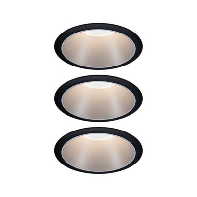 Three round recessed lights with black frame and warm white light for modern indoor lighting