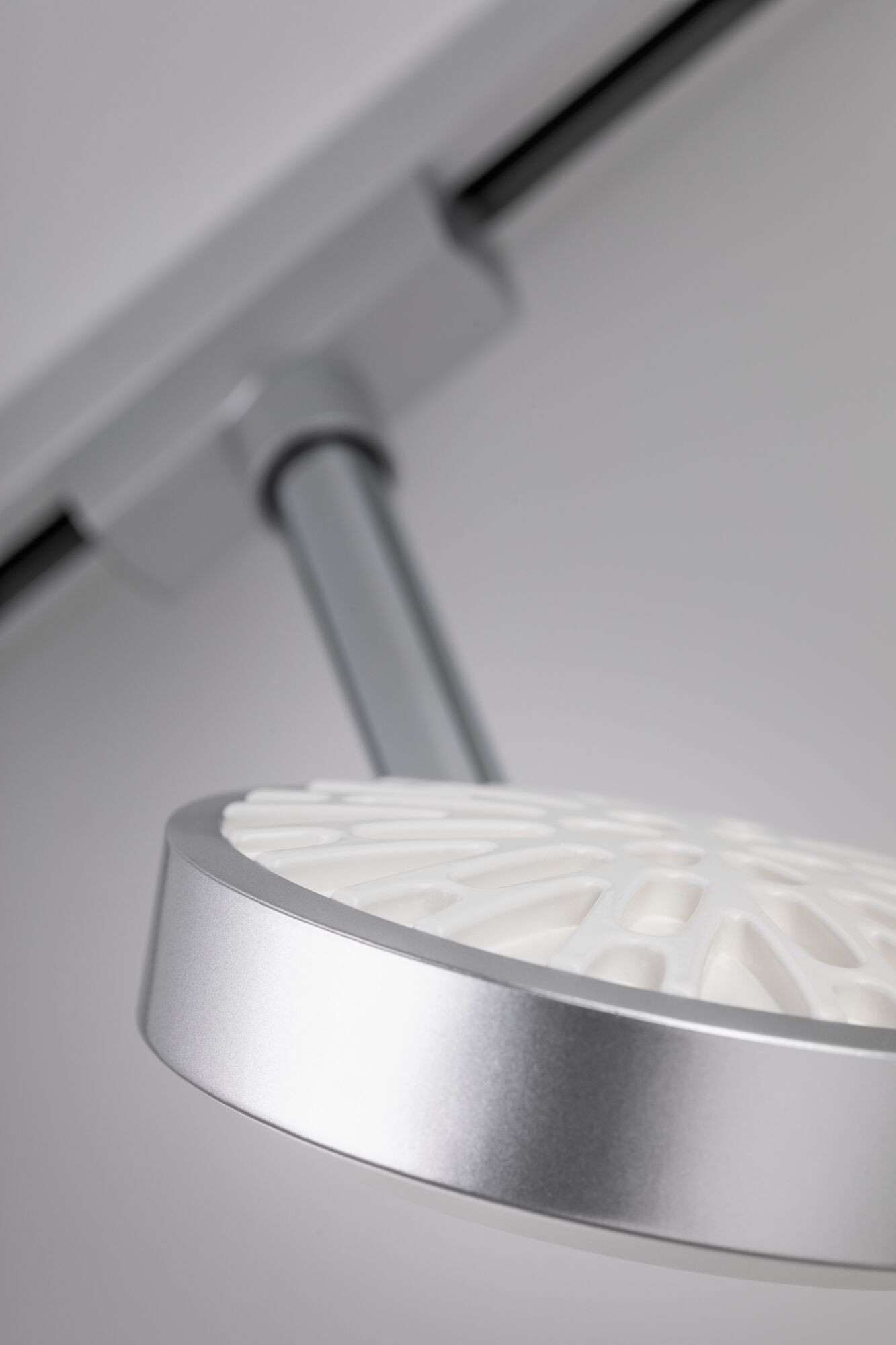 Modern silver LED ceiling spotlight with white diffuser and adjustable arm for accent lighting