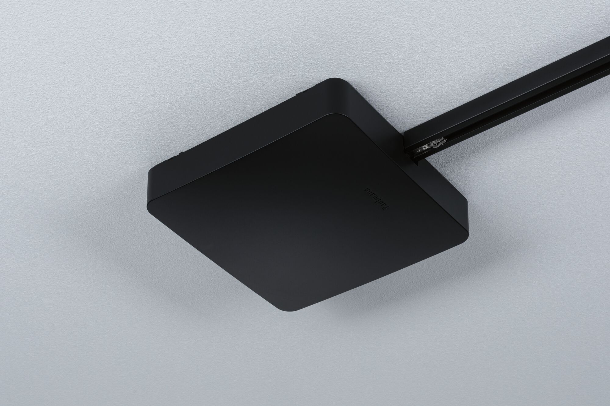 Black square metal ceiling light with sleek surface for modern interior lighting solutions.