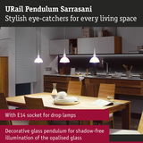 Modern white opal glass pendant lamps above wooden table in stylish kitchen setting