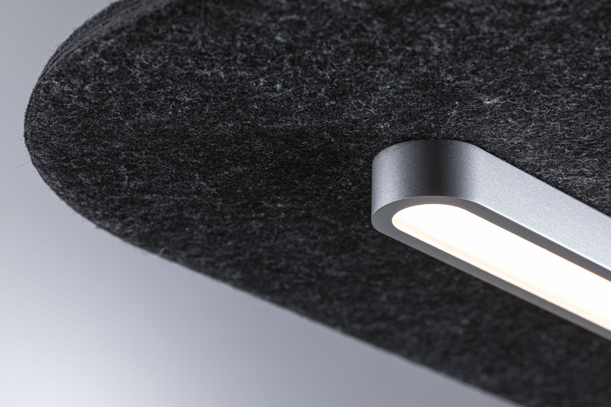 Modern LED ceiling light with grey aluminum housing and black felt shade for living spaces.