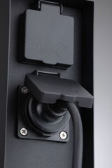 Black IP44 socket with protective cover and connected cable made of durable plastic for outdoor use