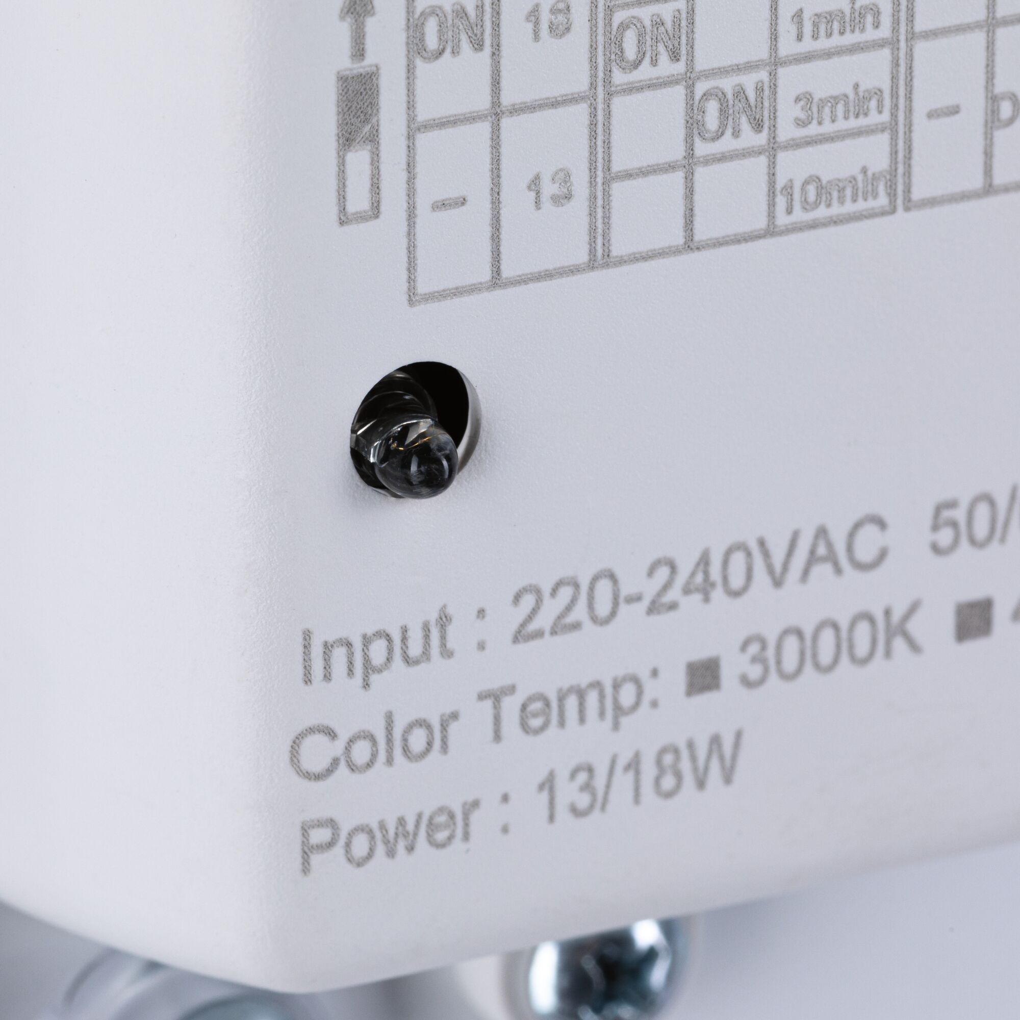 Close-up of white device showing input voltage, color temperature 3000K, and power 13/18W specifications