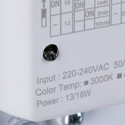 Close-up of white device showing input voltage, color temperature 3000K, and power 13/18W specifications