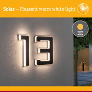 Solar illuminated house number 13 with warm white light on grey exterior wall for outdoor use