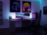 Modern gaming setup with ultrawide monitor, RGB keyboard, and LED-lit PC in dark room ambiance